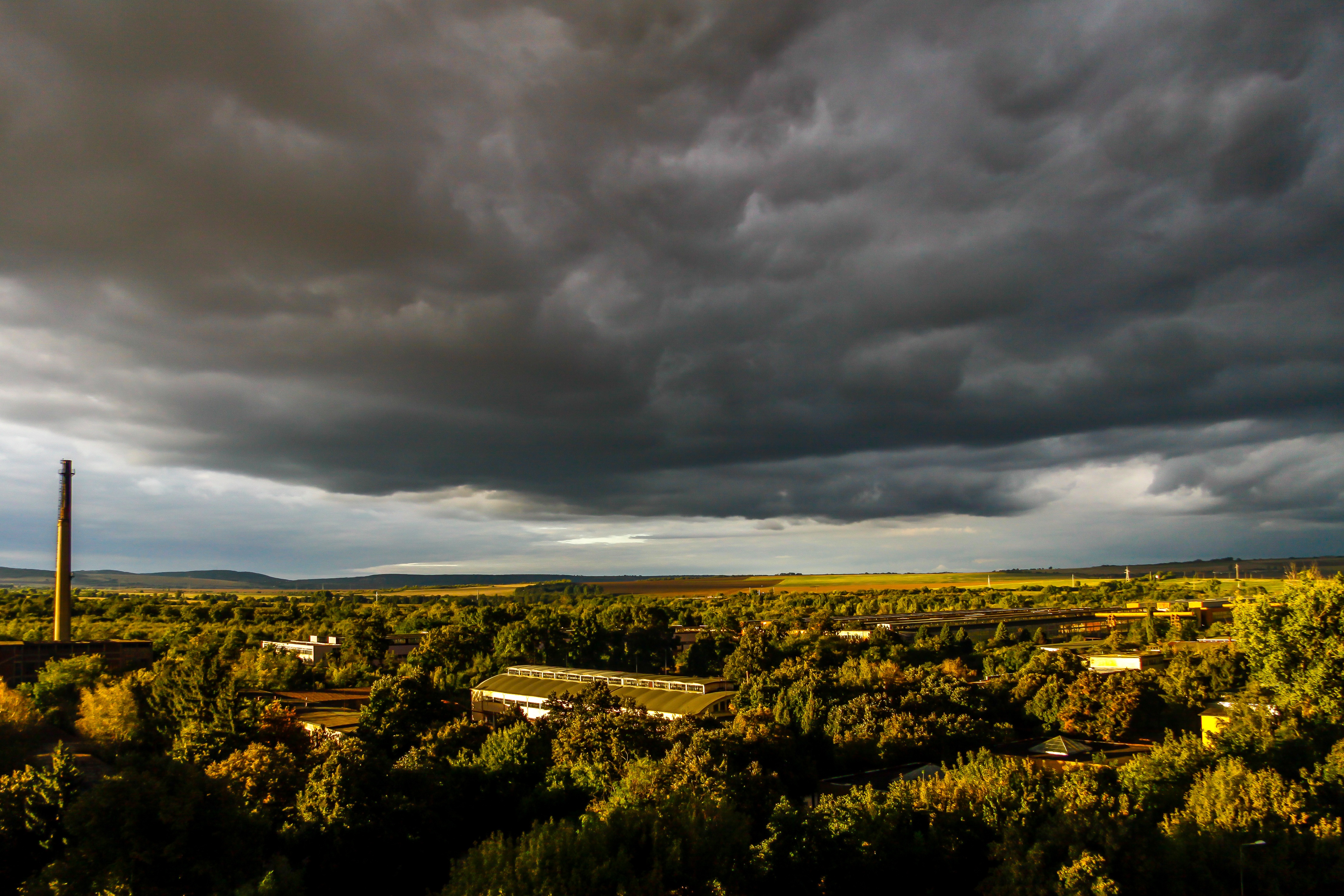 Dramatic Field Under Dark Clouds Wallpapers