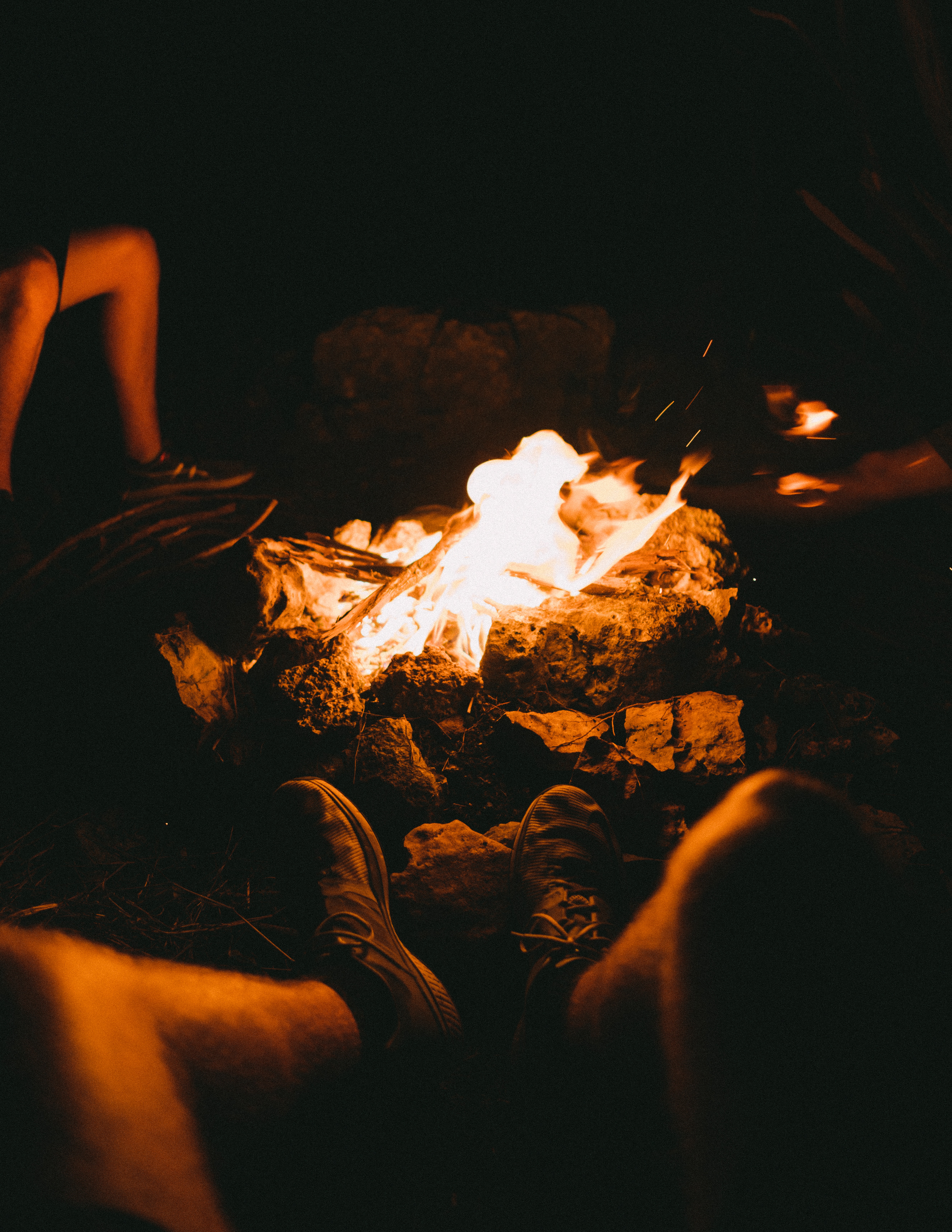 People Sitting Around Campfire In Dark Night Wallpapers