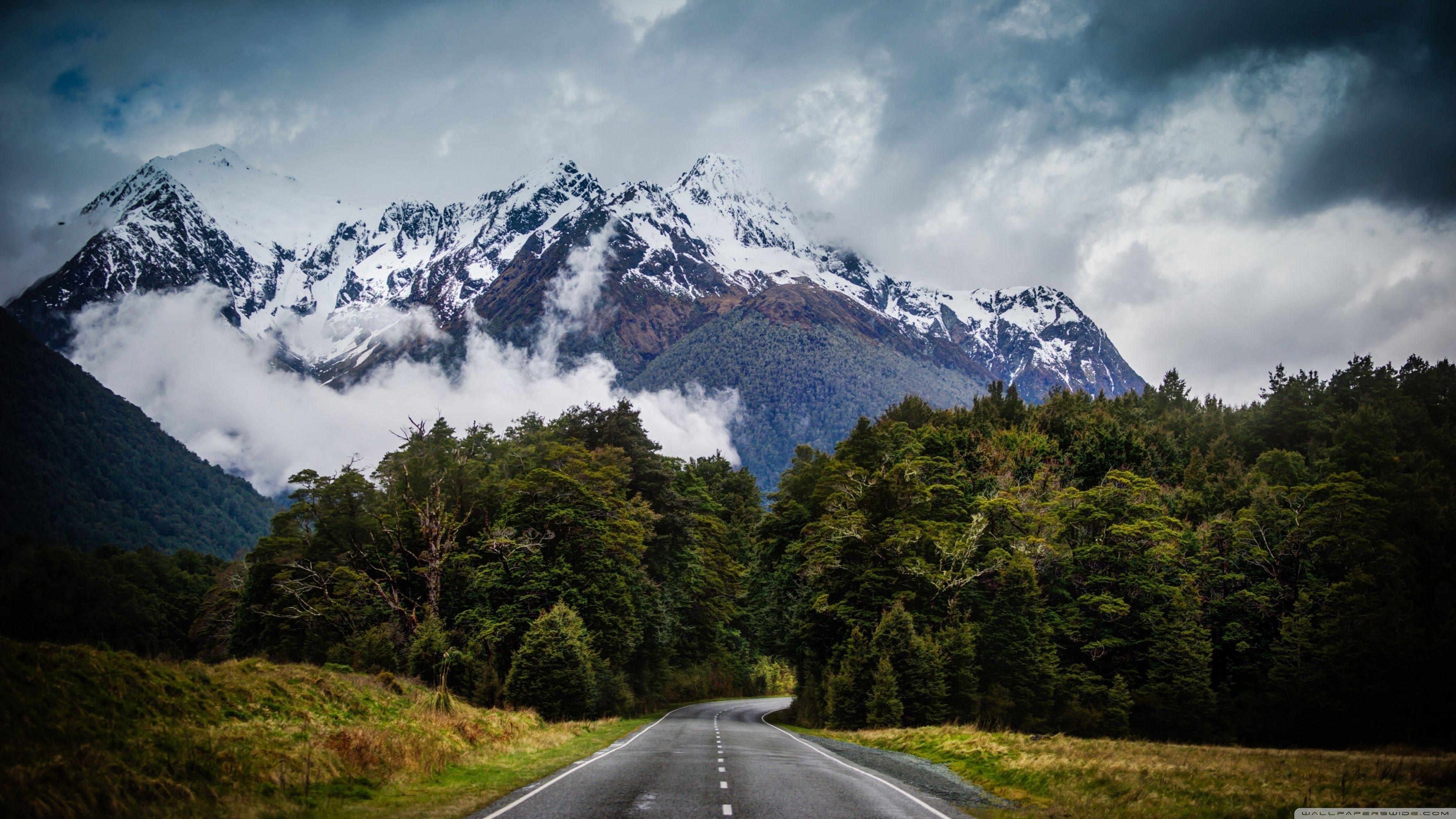 Road With Background Of Mountains And Clouds