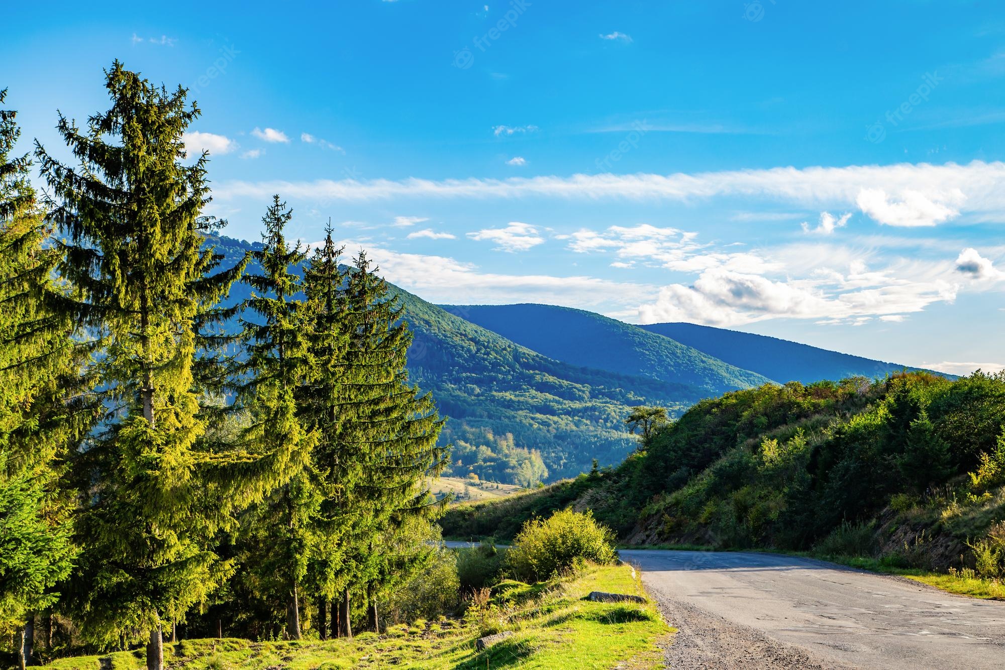 Road With Background Of Mountains And Clouds